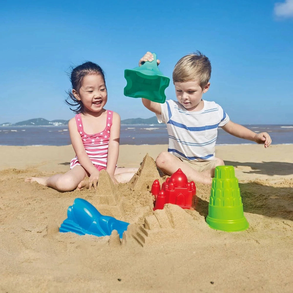 Hape Parthenon sand mold toys; two kids play with green, blue and red molds on the beach