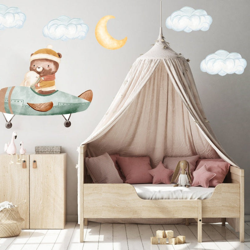 Hello Beautiful Designs reusable nursery wall sticker of a bear and bunny flying in a green plane beneath a moon and clouds