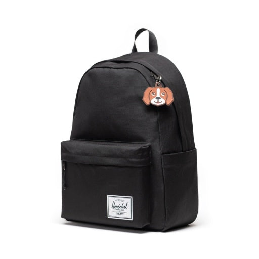 Herschel Dog Bag Charm in Brown Dog, shown attached to a black backpack.