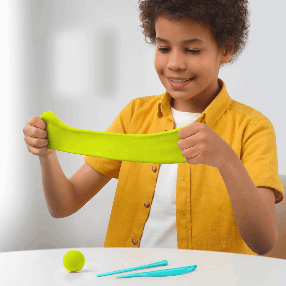 Hey Clay Motors Eco Cars play dough set; child stretches neon lime green clay with blue shaping tools.