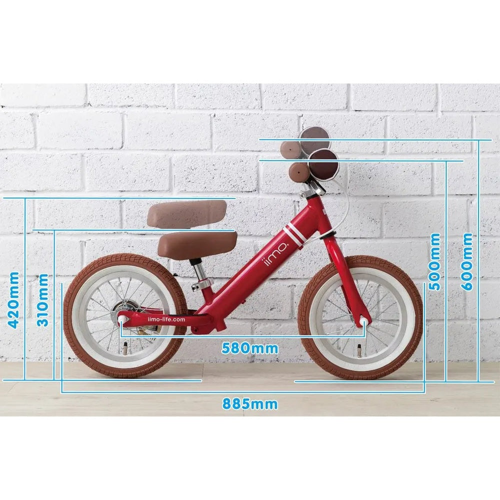 Iimo Balance Bike red frame with brown seat and grips, white rims rolling on a wooden floor.