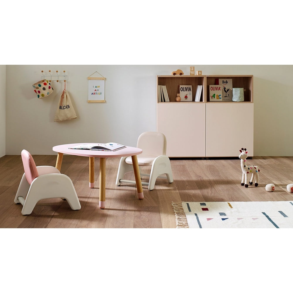Iloom Atti I Chair set in pastel pink and white around a round table in a cozy kids' playroom.
