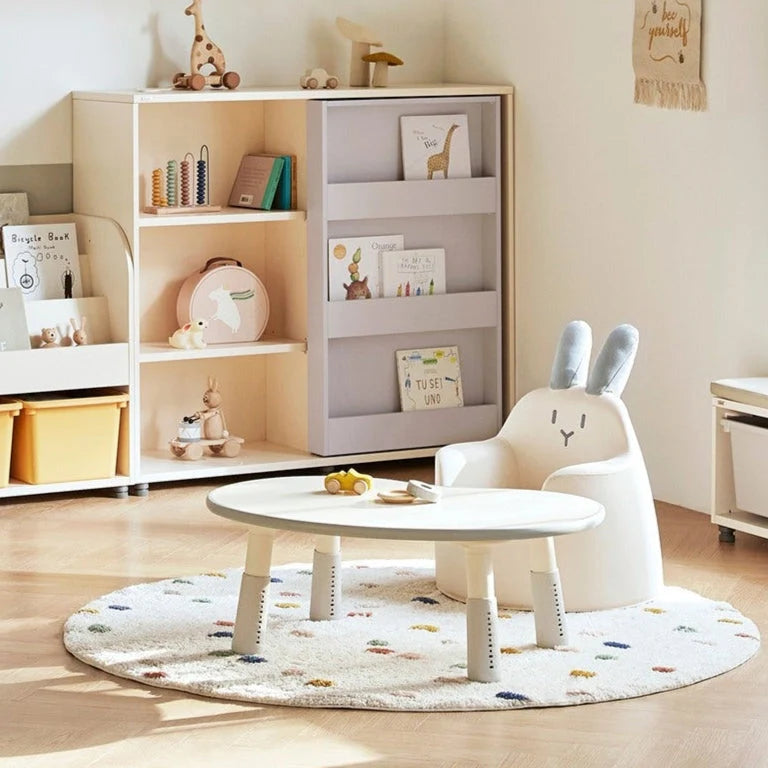 Ivory Bunny Aco at a child-sized table in a playroom; other furniture is not included.