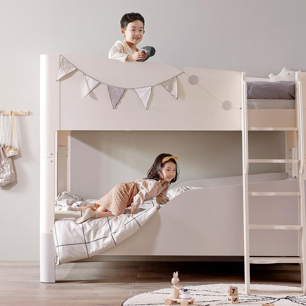 Iloom Coco Kids white bunk bed with ladder and two mattresses; kids playing on top and bottom.