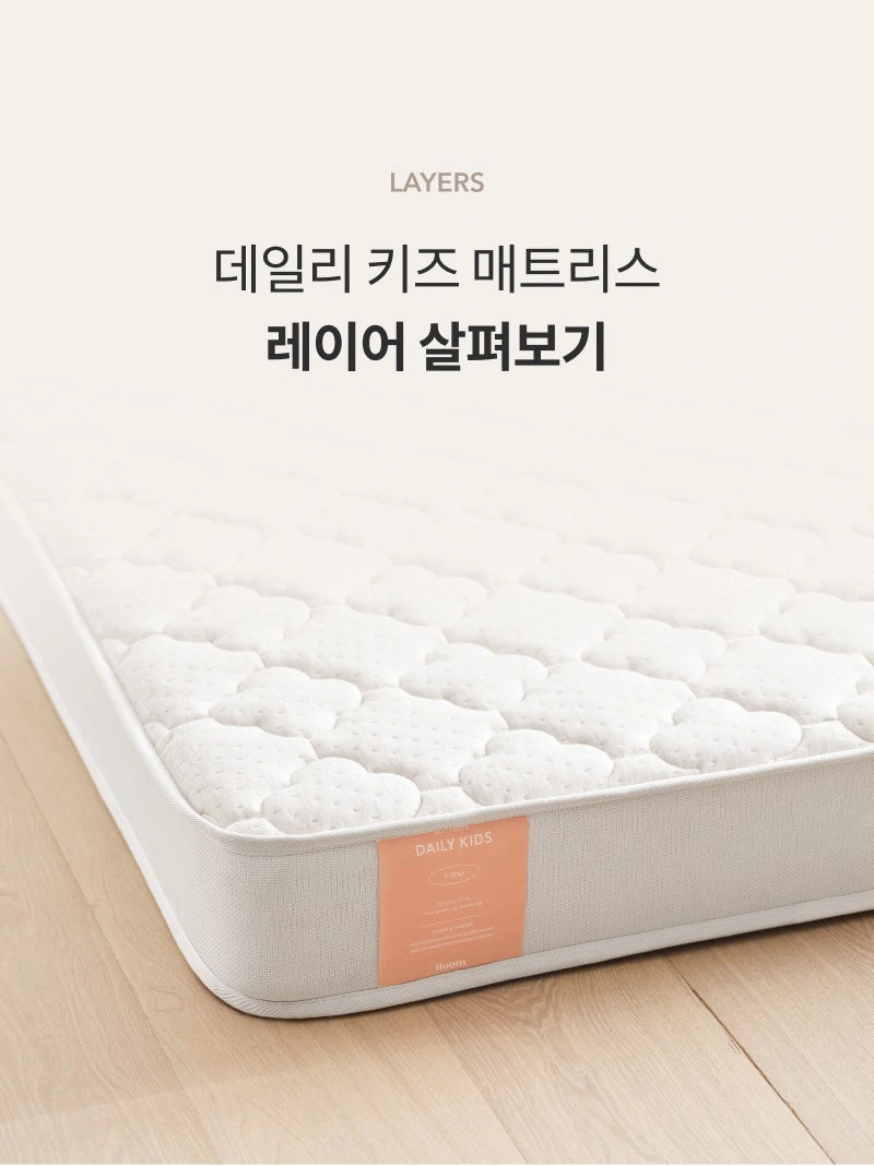 Daily Kids Layers introduction showing the mattress corner and a product label marked Firm, which differs from the manufacturer comparison.