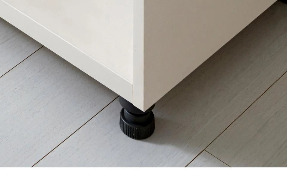 Full manufacturer photograph of a floor-leveling glide beneath the bookcase corner.