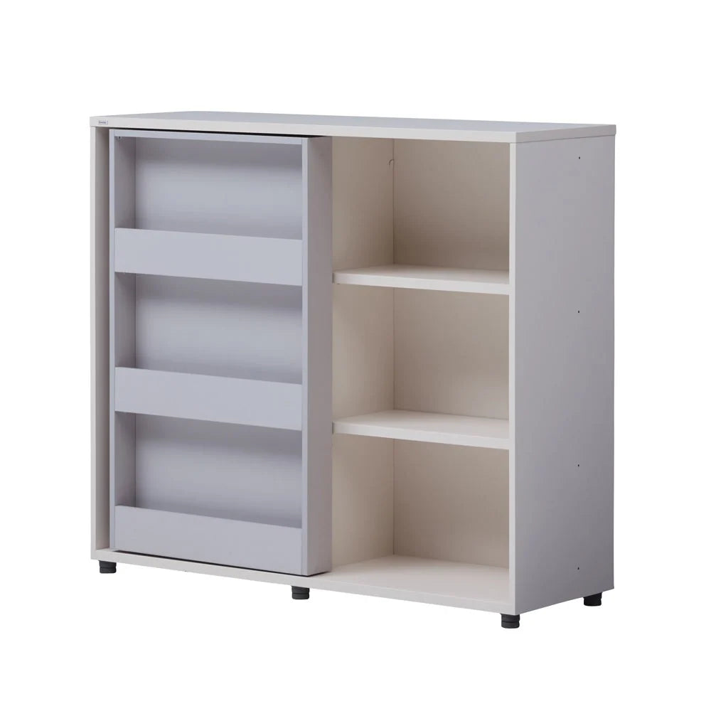 Complete existing angled studio view of the ivory bookcase, grey sliding display door and shelving.