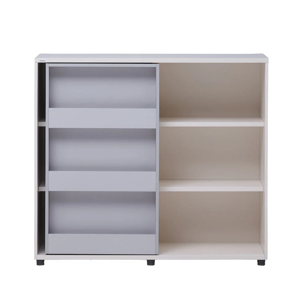 Complete existing front studio view of the ivory Eddi bookshelf with its grey face-out sliding door.