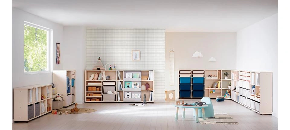 Full wide playroom photograph including the sliding bookshelf among separate storage units.