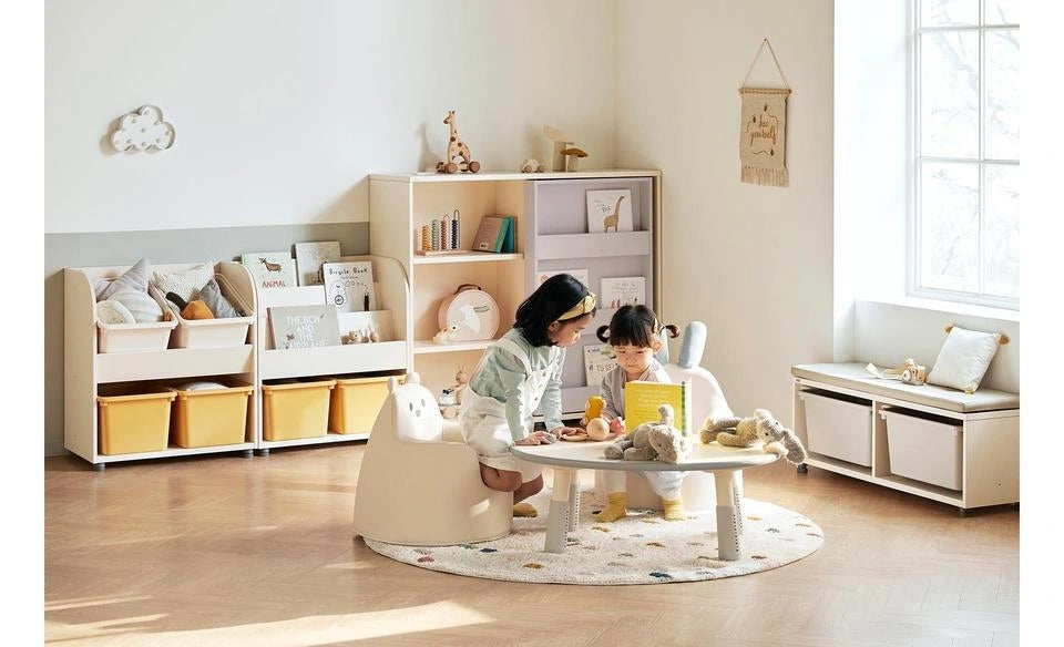 Complete manufacturer reading-room photograph with the sliding bookshelf, separate table, chairs and furnishings.
