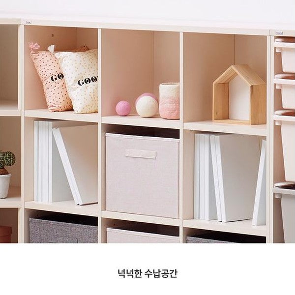 ILOOM Eddi Kids 3-Story Bookshelf in beige wood with fabric storage bins and decor items