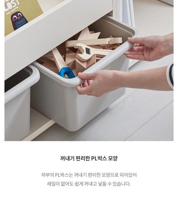 Grey lower PL bin pulled from a coordinated Eddi Kids front-facing bookcase; the manufacturer uses this photograph to illustrate the lower-bin removal design.