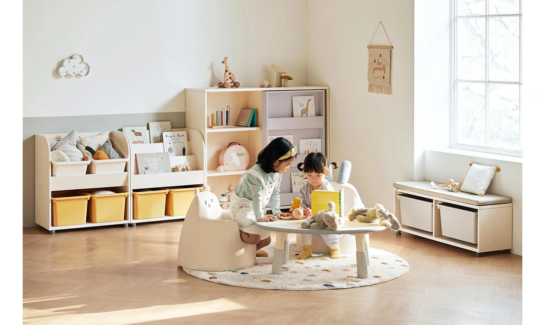 Children reading and playing at a separate table in a room with Eddi Kids low storage units behind them.