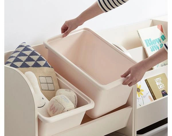 Hand removing a shallow upper bin from the toy storage unit, shown in a manufacturer close-up.