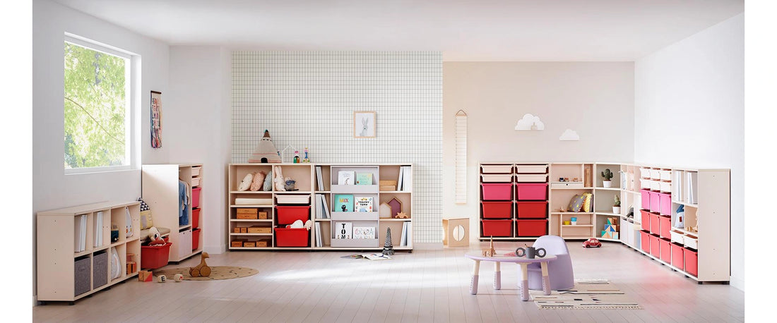 Red-bin Eddi cabinet among coordinated bookcases and other furniture in a complete children’s room.
