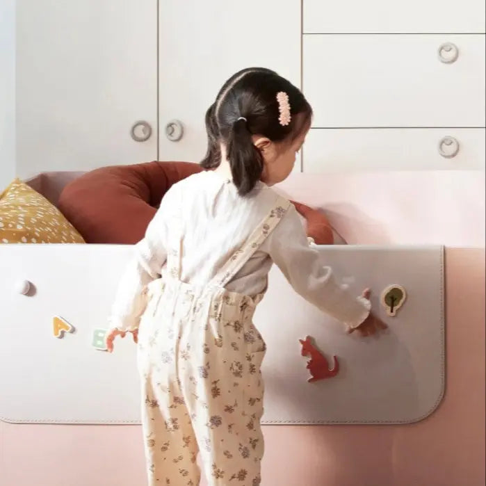 Iloom Eddi Kids Low Bed 1100W toddler bed in pale pink, where a child opens the curved safety panel with magnets.