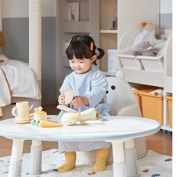 ILOOM Growing Desk Peanut 800W round white activity table with wooden toys and child playing