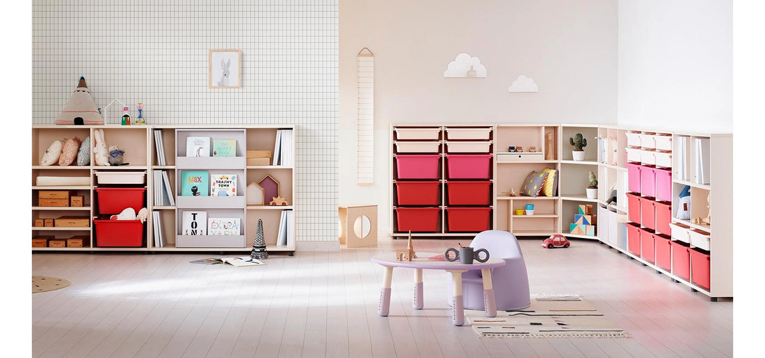A small desk beside open storage: The manufacturer’s room illustrates a lilac-accent version of the same floor-desk design.