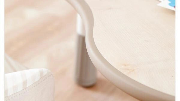 Curves around the peanut-shaped surface: The close-up shows the narrowed waist and moulded edge of the peanut-shaped top.