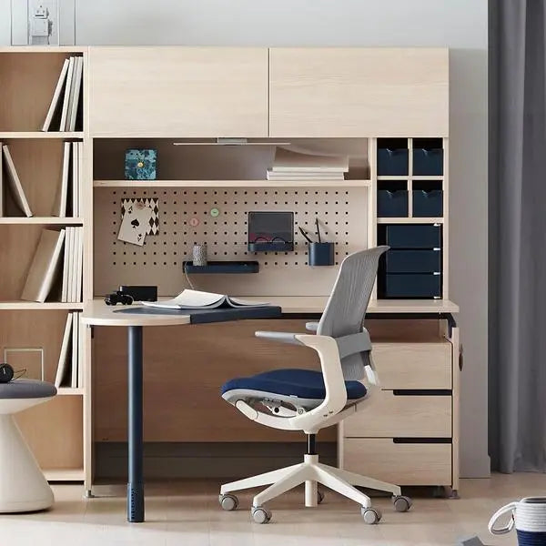 Iloom Oliver Chair with mesh back and white frame swivels at a modern home office desk, wheels rolling.