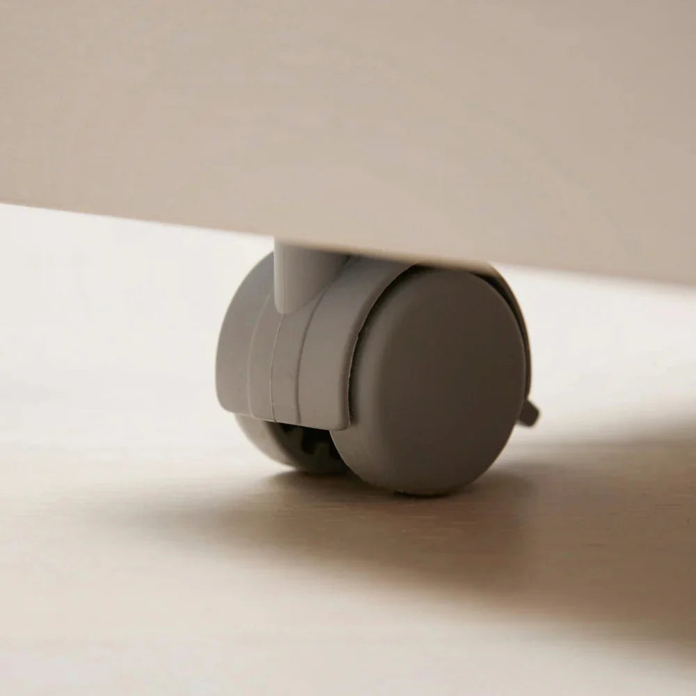 Close-up of a Roy Mono nylon caster beneath the cabinet base.