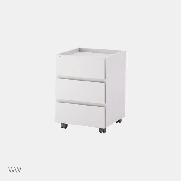 WW White Roy Mono three-drawer cabinet, offered under the Ivory option, with four small casters against its original grey studio background.