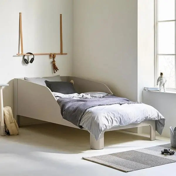 Iloom Tinkle Pop 1 Story Bed in light gray with white and gray bedding, a low-profile toddler bed with rounded legs.