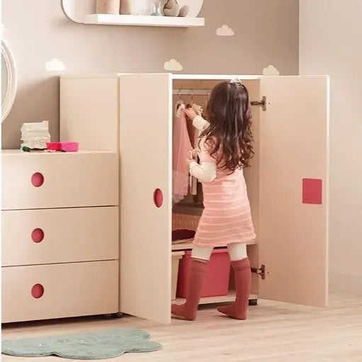 Iloom Tinkle Pop Wardrobe 800W in pale pink; girl hanging clothes inside with doors open and red knobs.