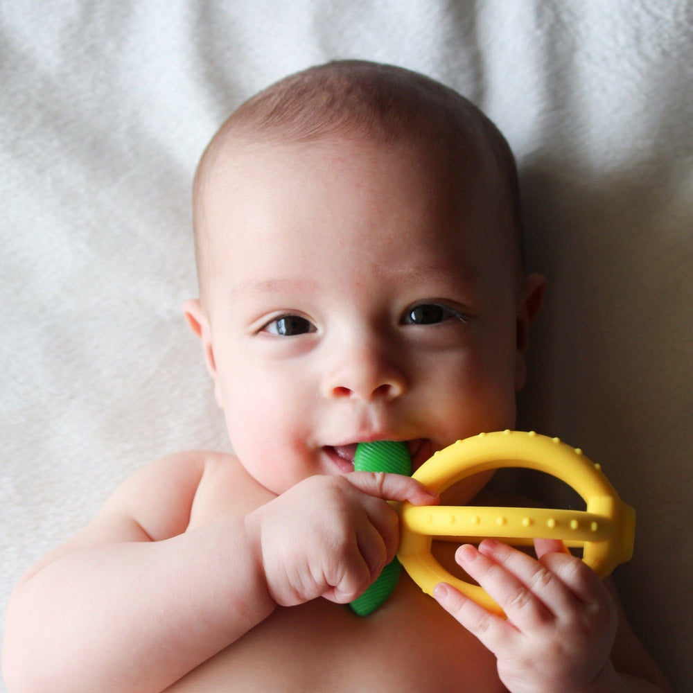 Itzy Ritzy Bitzy Biter Lemon Ball teether with yellow ring and green bite handle