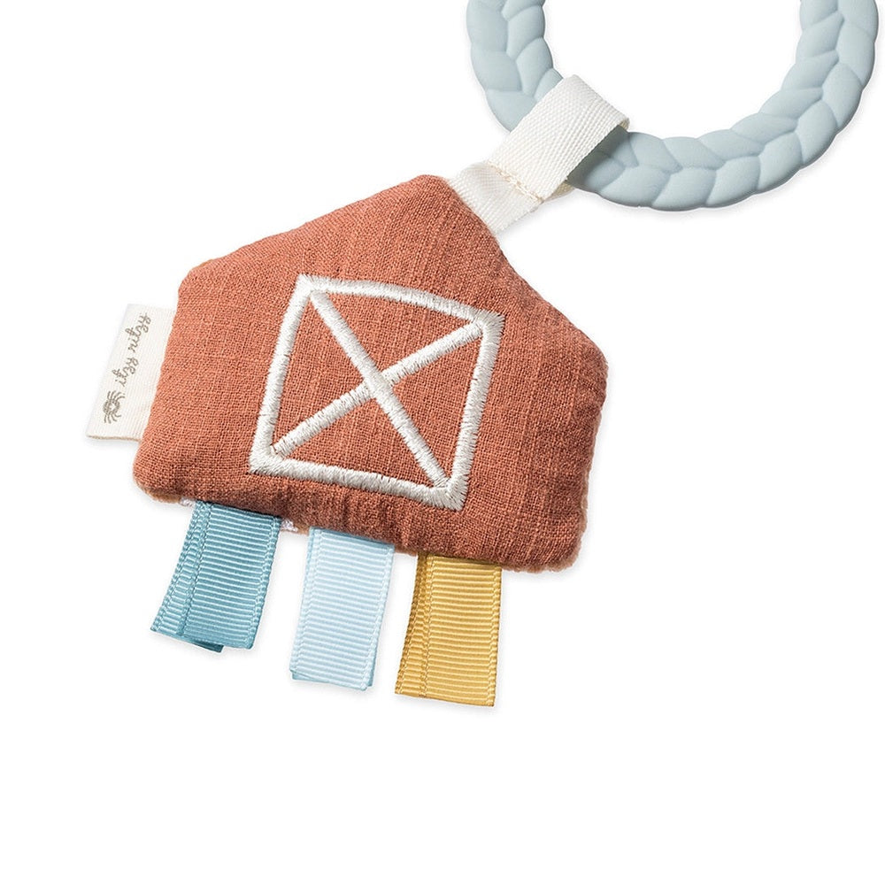 Itzy Ritzy Bitzy Busy Gift Set plush teether with orange body, white diamond embroidery, pastel ribbon tabs on a light blue braided ring