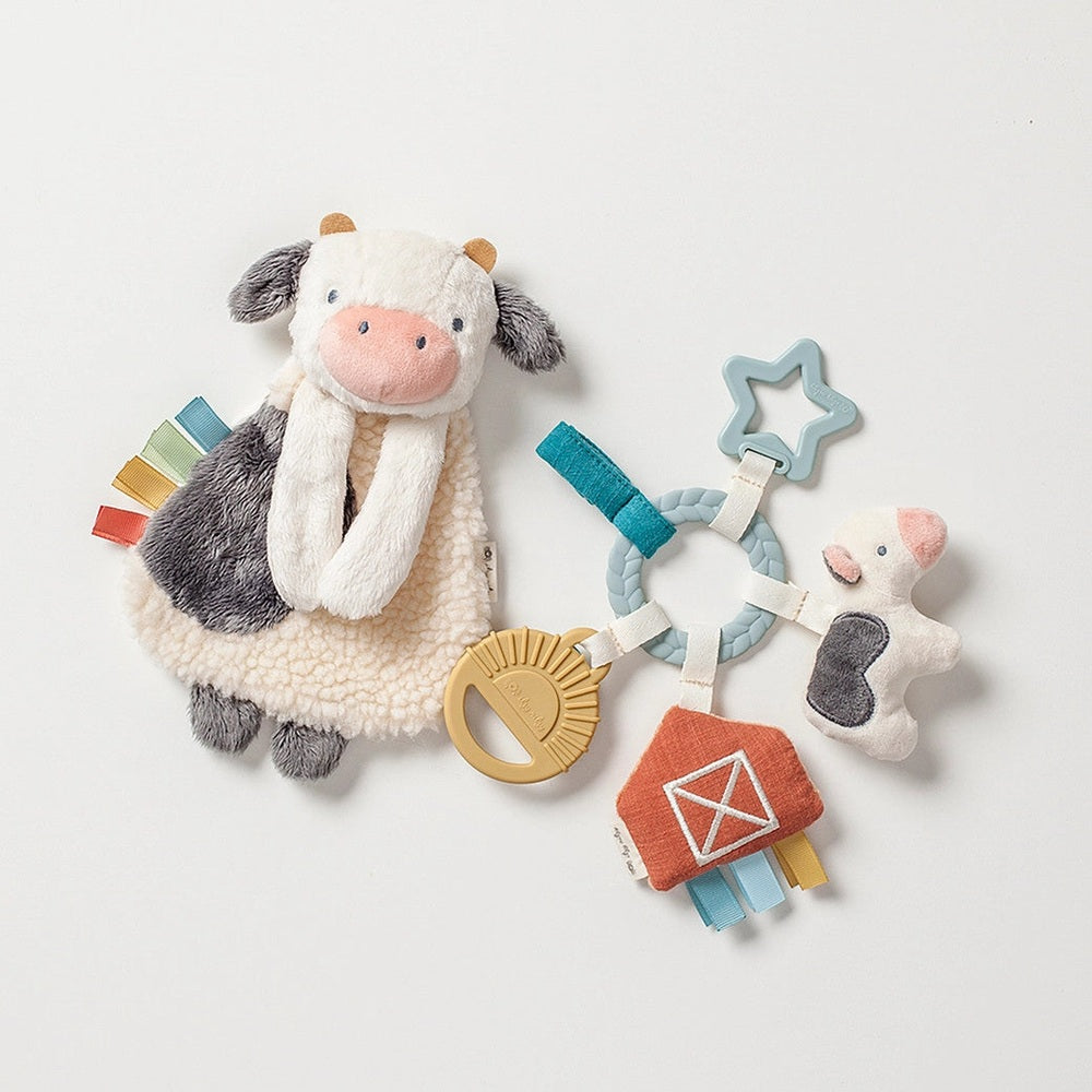 Itzy Ritzy Bitzy Busy Gift Set with plush cow toy, star teether, ring rattle and colorful ribbons