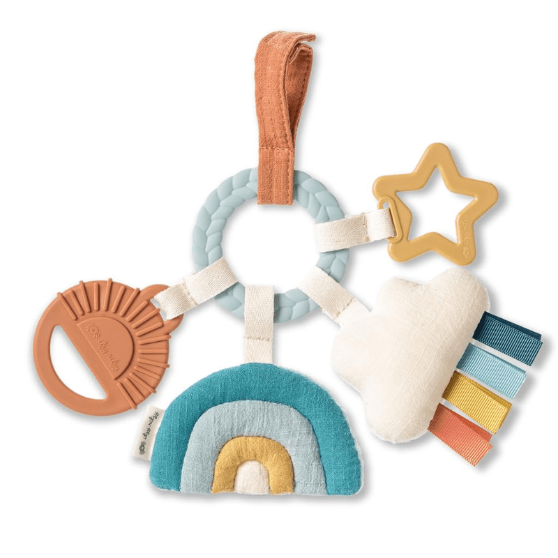 Itzy Ritzy Bitzy Busy Ring teething activity toy with pastel braided ring, rainbow fabric, star teether, and ribbon tags