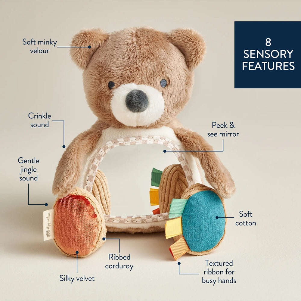 Itzy Ritzy Bitzy Mirror Theo the Bear plush in soft brown minky velour with a peek mirror and textured ribbons.