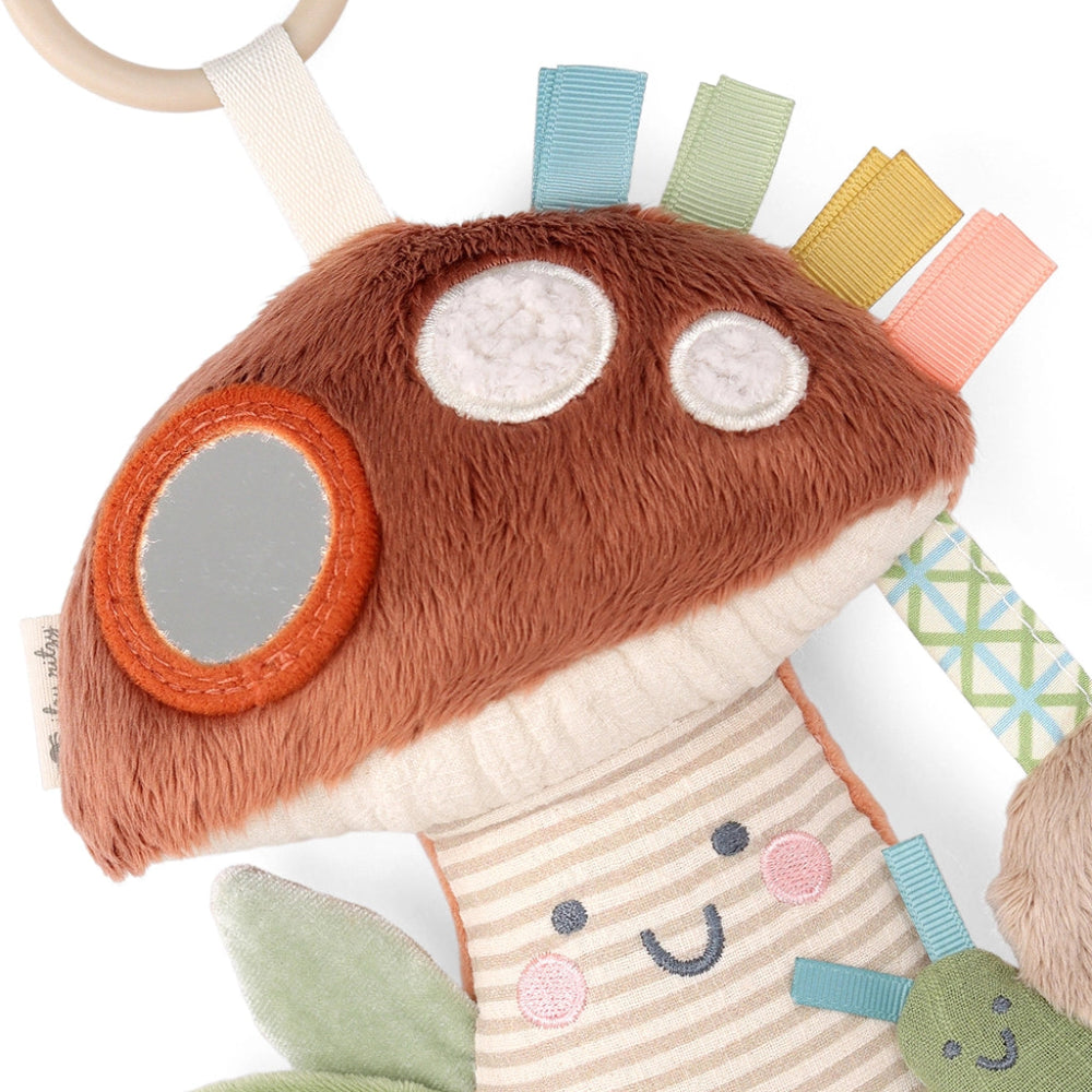 Itzy Ritzy Bitzy Traveler plush baby toy with brown fuzzy head and pastel ribbon tags