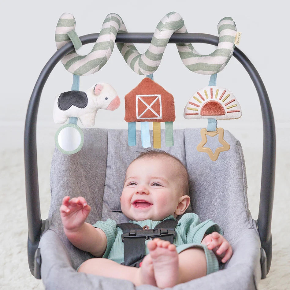 Itzy Ritzy Itzy Bitzy Spiral Car Seat Activity Toy, striped arch with three plush shapes: cow, barn, sun