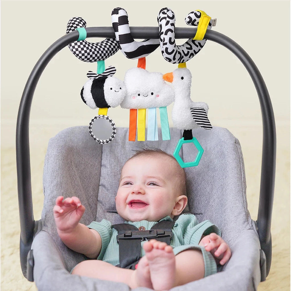 Itzy Ritzy Itzy Bitzy spiral car seat activity toy with plush animals and colorful ribbons, smiling baby in car seat