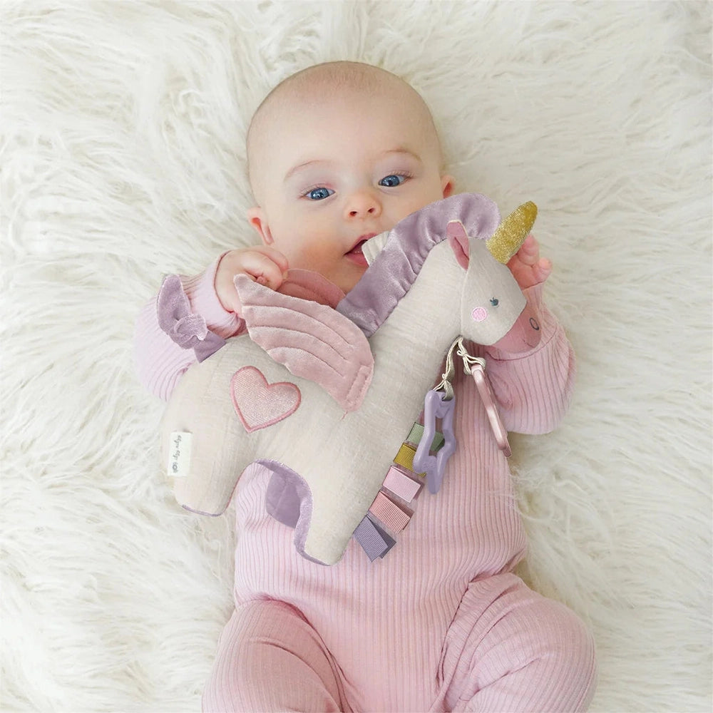 Itzy Ritzy Itzy Friends Link & Love Activity Plush unicorn in pastel pink and lavender with teething clips