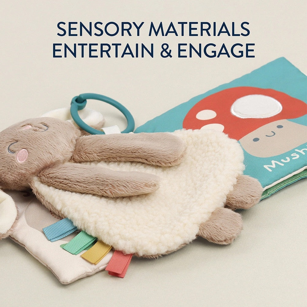 Itzy Ritzy Itzy Learn & Snuggle Gift Set featuring plush bunny teether, teal ring, and rainbow ribbons