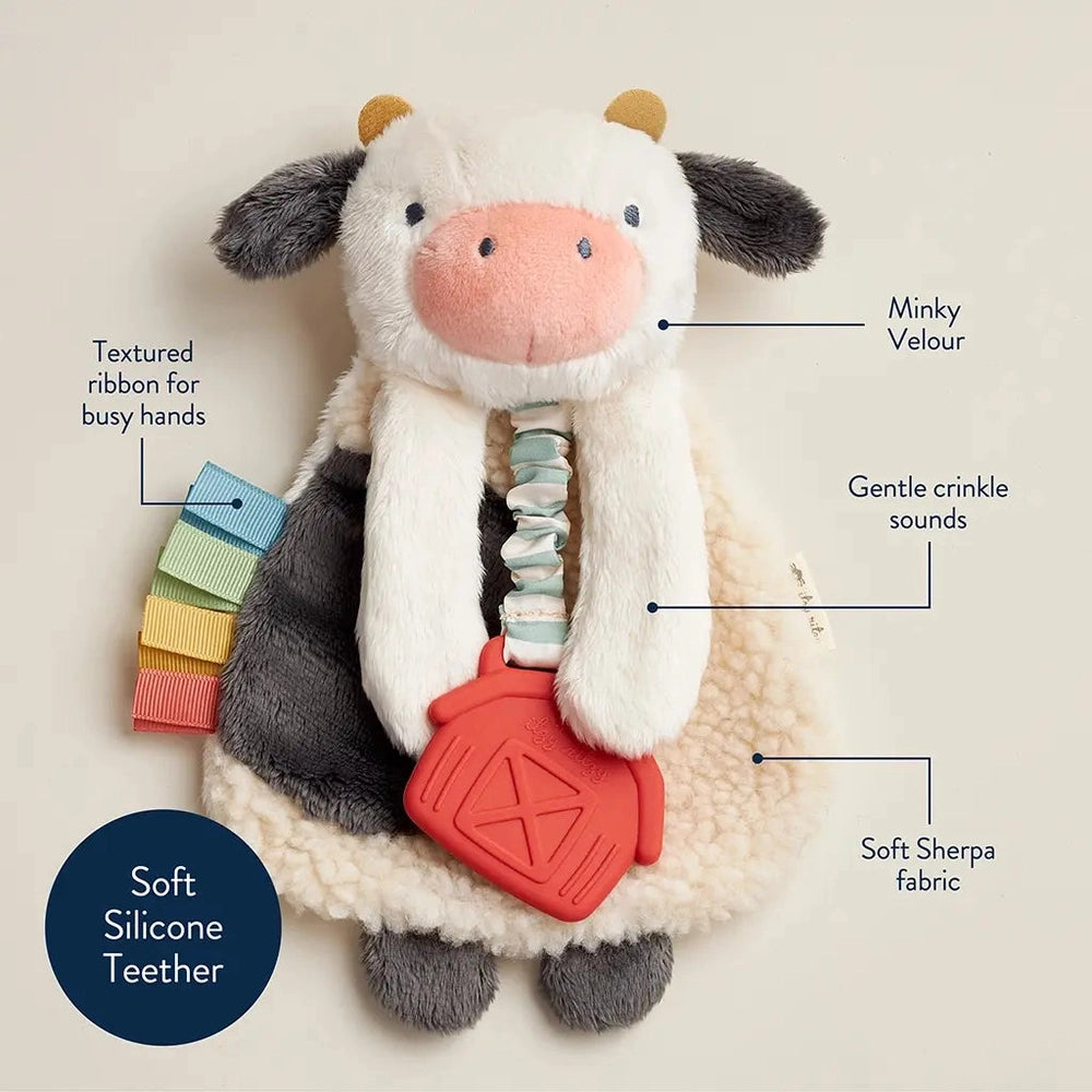Itzy Ritzy Lovey plush cow teether with soft minky velour, sherpa fabric and textured ribbon tabs