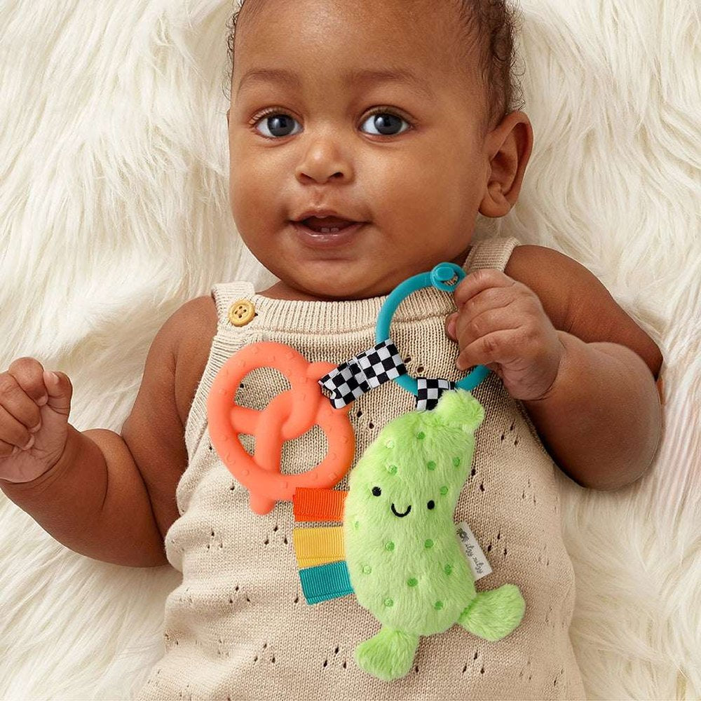 Itzy Ritzy Itzy Pal Parker The Pickle teething toy, lime plush pickle with orange ring and checkered ribbon