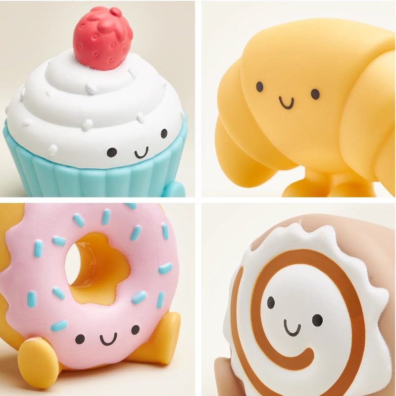 Itzy Ritzy bakery spill-and-fill toy set with four silicone figures: cupcake, donut, croissant, cinnamon roll.