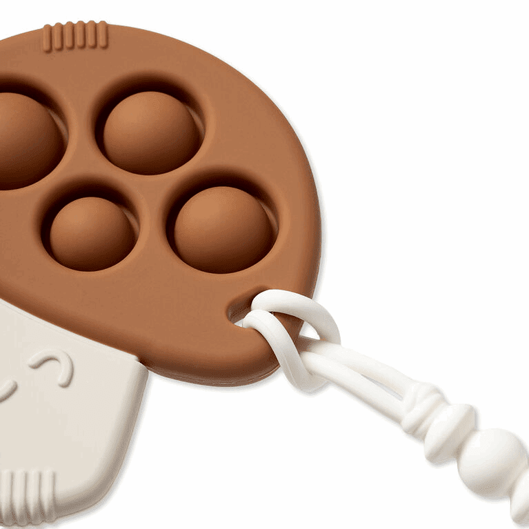 Itzy Ritzy Itzy Pop silicone fidget toy in brown with four bubble recesses and white cord