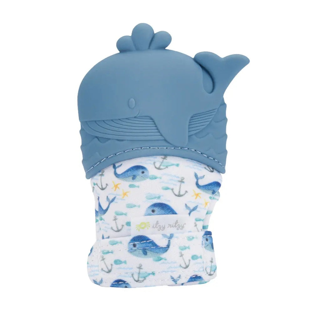 ITZY RITZY Itzy Ritzy Itzy Silicone Teething Mitts blue silicone teething mitt with whale motif worn over patterned fabric and textured for
