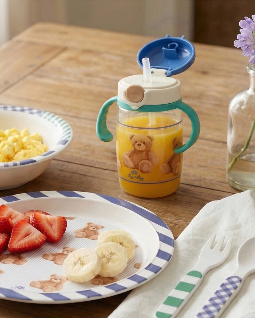 Itzy Ritzy Itzy Sips Straw Cup in Bear, Bear straw cup styled on a table