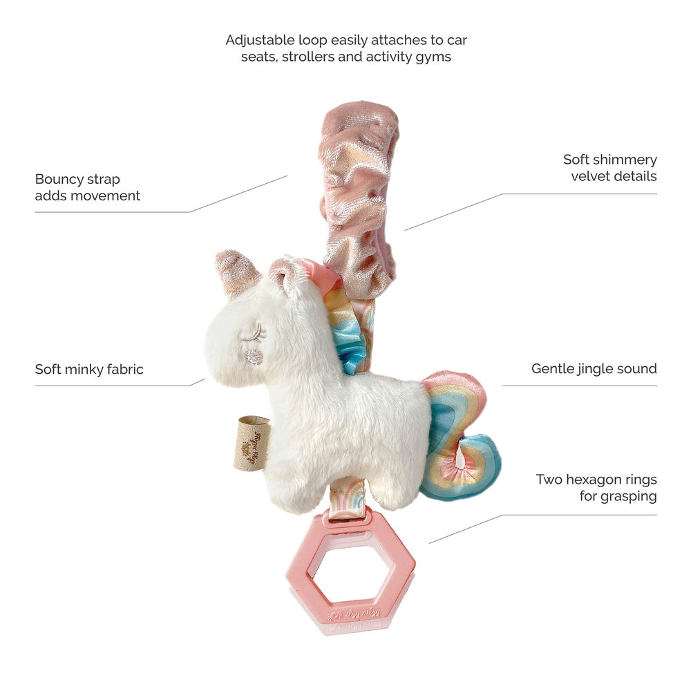 Itzy Ritzy JingleB unicorn travel toy with soft white plush, rainbow mane/tail, velvet accents, pink hexagon ring