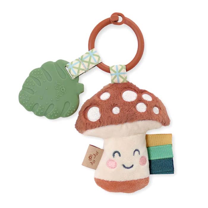 Itzy Ritzy Pal plush and teether toy, mushroom character with green leaf teether and colorful ribbon tabs