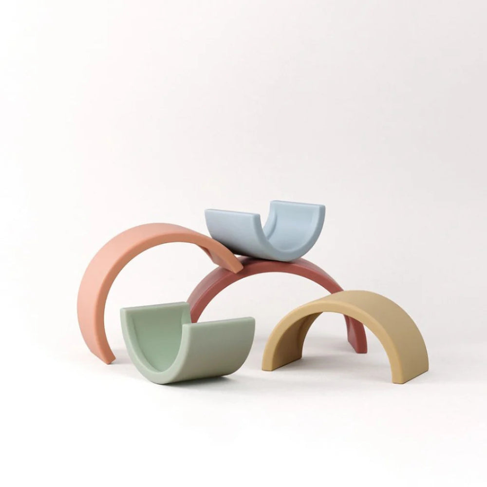 Ritzy Rainbow Stacking Toy by ITZY RITZY with pastel arch pieces in five colors