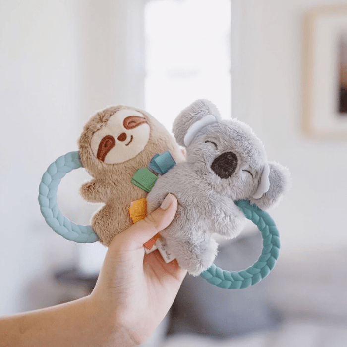 Itzy Ritzy Ritzy Rattle Pal plush rattle set with two sloth teether toys on teal braided rings.