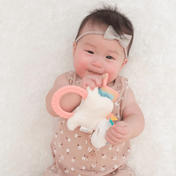 Itzy Ritzy Ritzy Rattle Pal plush rattle with teether for babies, cream plush and pink ring