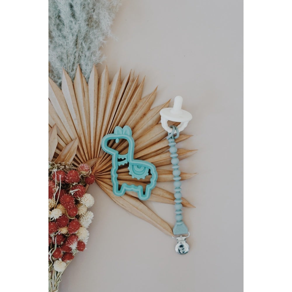 Itzy Ritzy silicone teether llama in teal with beaded clip and white ring top